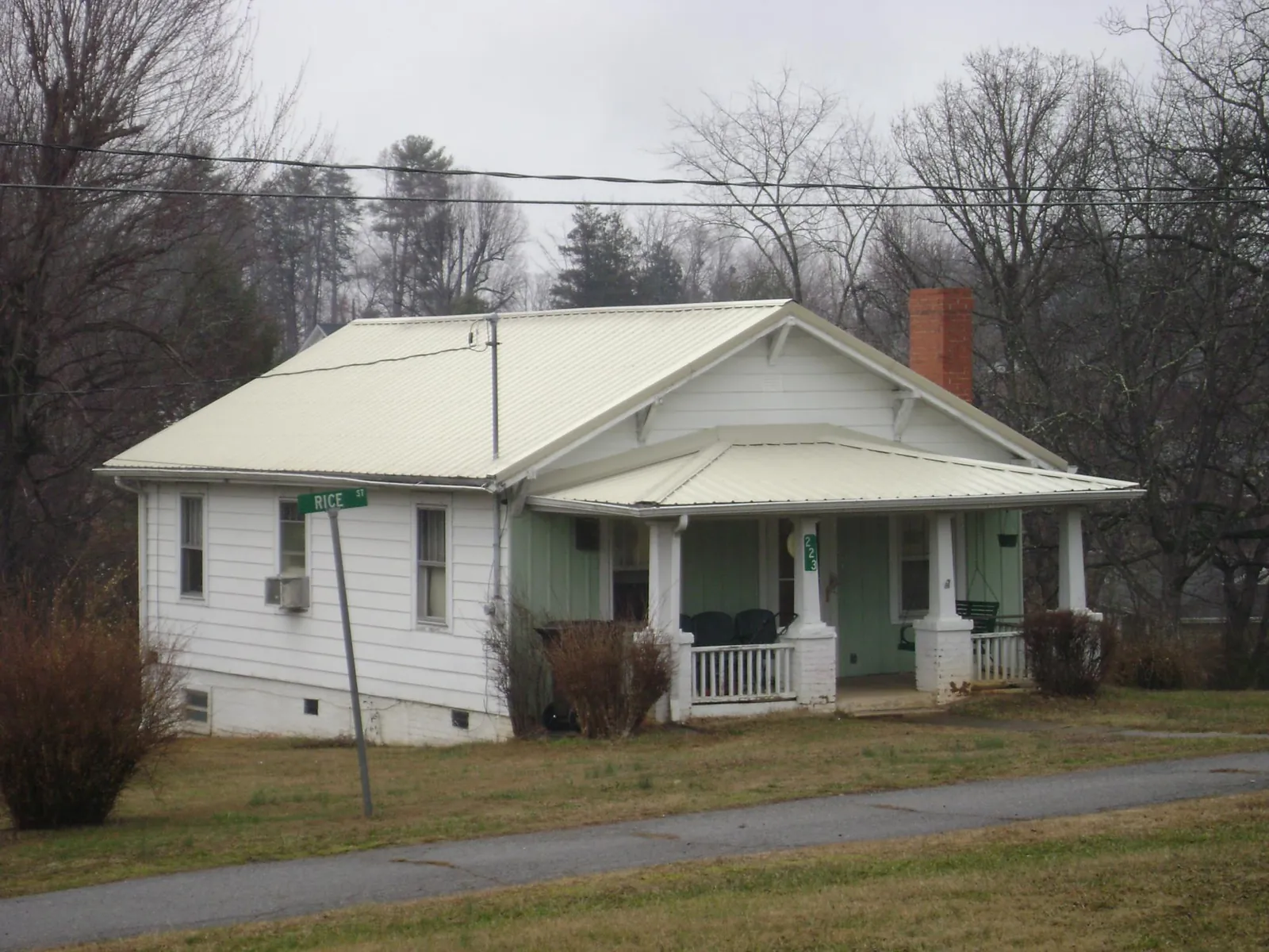 White metal roof on a craftsman bungalow at a street corner in Hobgood