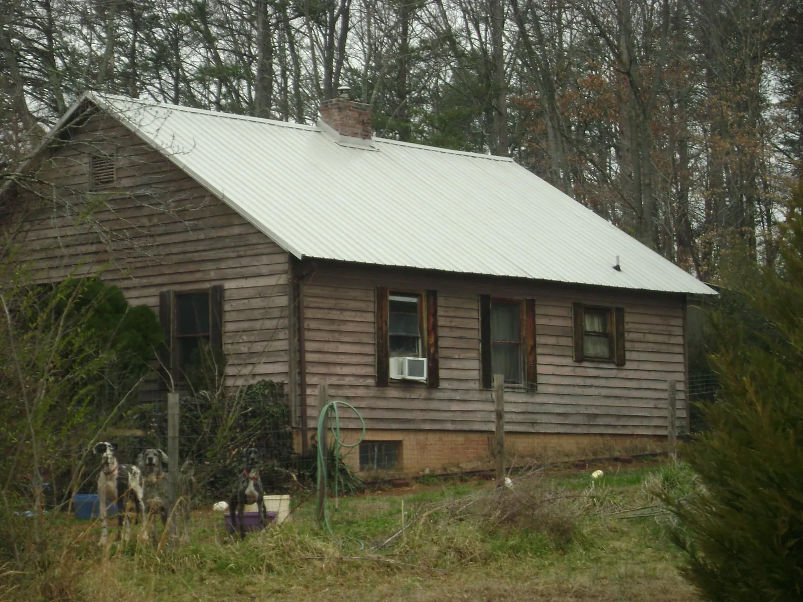 White metal roof on an old wood sided farmhouse, from a Metal Roof Installation job in Hobgood